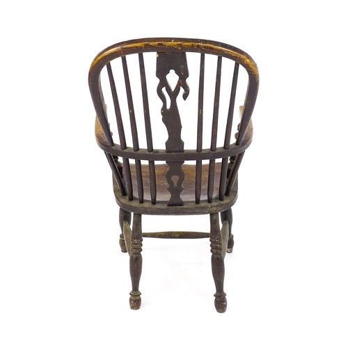 1768 - A mid 19thC ash and elm double bow back Windsor armchair, having a central pierced back splat above ... 