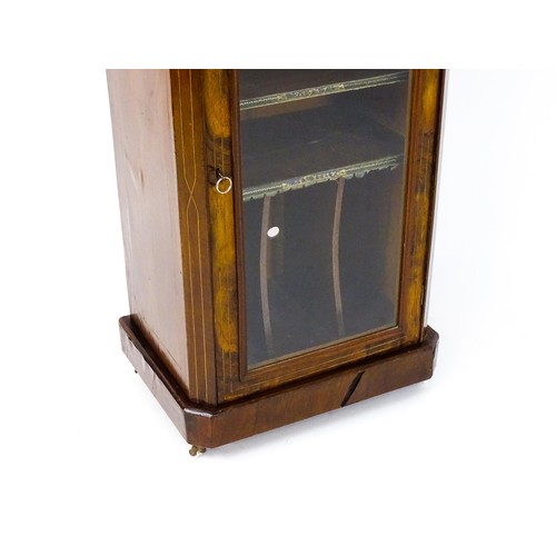 1773 - A late 19thC / early 20thC burr walnut veneered music cabinet with decorative stringing and having a... 