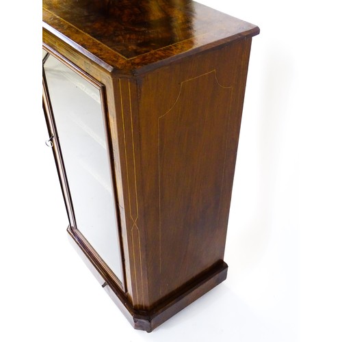 1773 - A late 19thC / early 20thC burr walnut veneered music cabinet with decorative stringing and having a... 