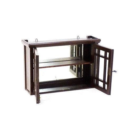 1774 - An Aesthetic style hanging wall cabinet with a mirrored back, astragal glazed doors and brass decora... 