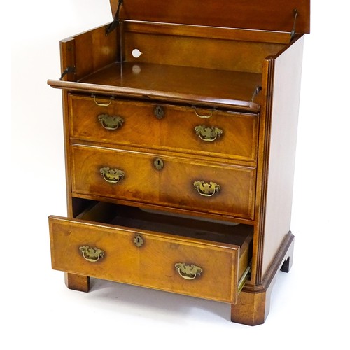 1776 - A George II style walnut record cabinet. with a crossbanded and hinged top above feather banded faux... 