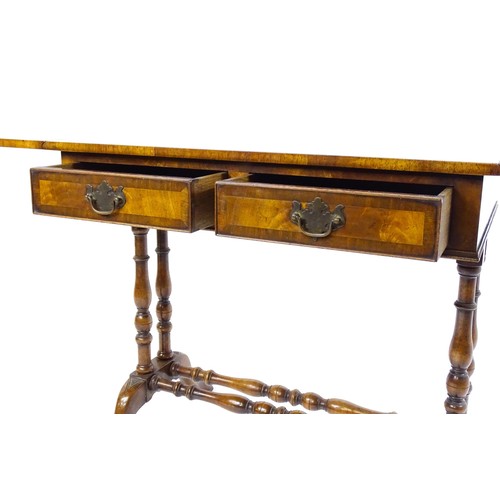 1777 - A 20thC walnut sofa table with a crossbanded top, drop leaves, and two frieze drawers. The top raise... 