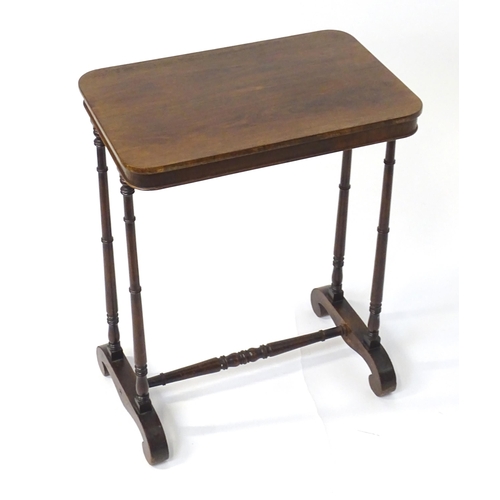 1779 - A mid 19thC rosewood side table, having an oblong top above four finely turned supports connected to... 