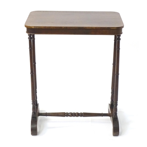 1779 - A mid 19thC rosewood side table, having an oblong top above four finely turned supports connected to... 