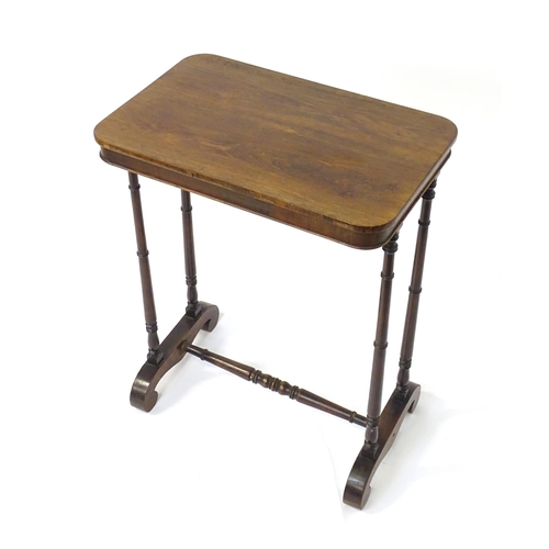 1779 - A mid 19thC rosewood side table, having an oblong top above four finely turned supports connected to... 