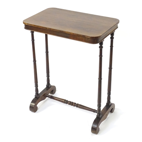 1779 - A mid 19thC rosewood side table, having an oblong top above four finely turned supports connected to... 