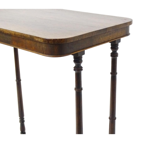 1779 - A mid 19thC rosewood side table, having an oblong top above four finely turned supports connected to... 