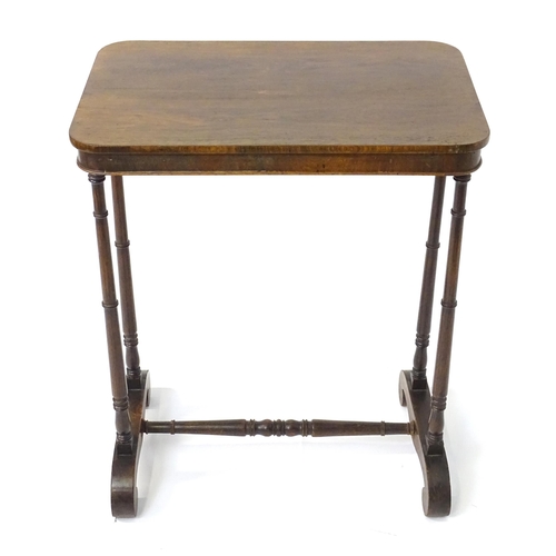 1779 - A mid 19thC rosewood side table, having an oblong top above four finely turned supports connected to... 