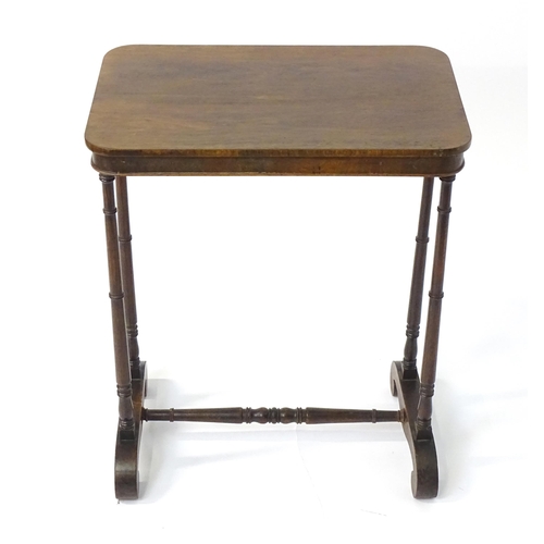 1779 - A mid 19thC rosewood side table, having an oblong top above four finely turned supports connected to... 