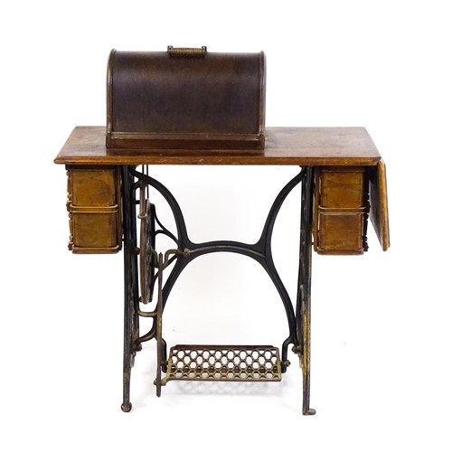 1784 - An early 20thC singer sewing machine mounted upon a table, with four short drawers, a drop flap and ... 