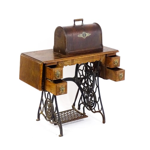 1784 - An early 20thC singer sewing machine mounted upon a table, with four short drawers, a drop flap and ... 