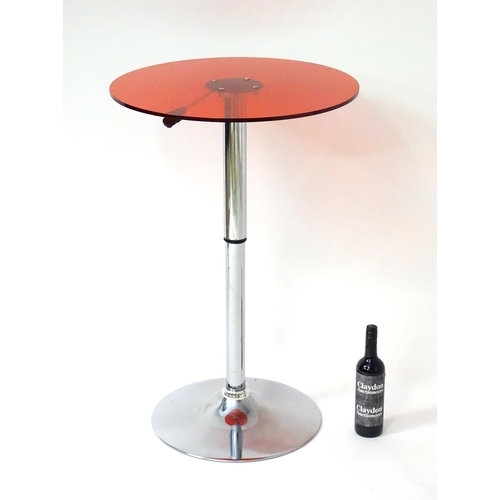 1788 - A late 20thC table with a circular lucite table top above a chromed stem and base, having a lever al... 