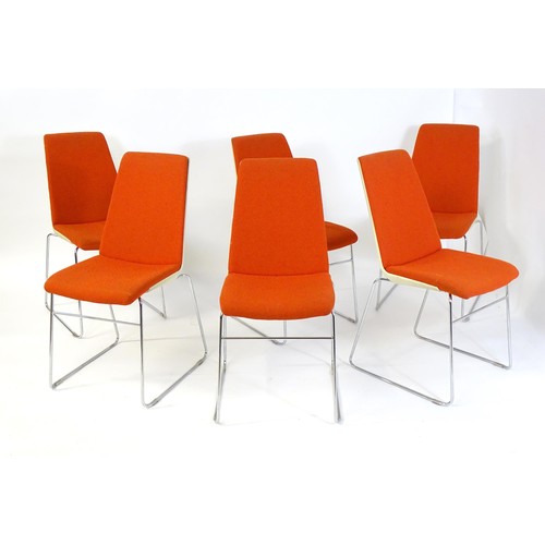 1793 - A set of six mid century stacking chairs, with orange and cream upholstery and raised on chromed tub... 