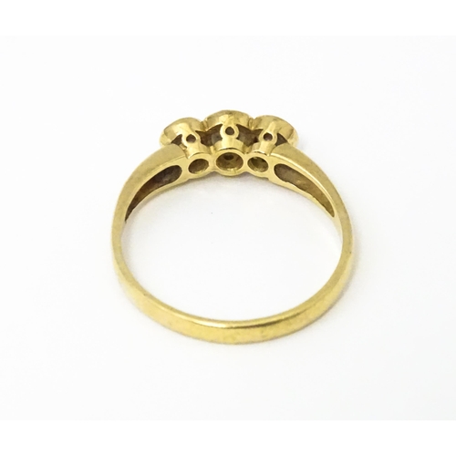 620 - A 9ct gold ring set with a trio cubic zirconia. Ring size approx. N 1/2