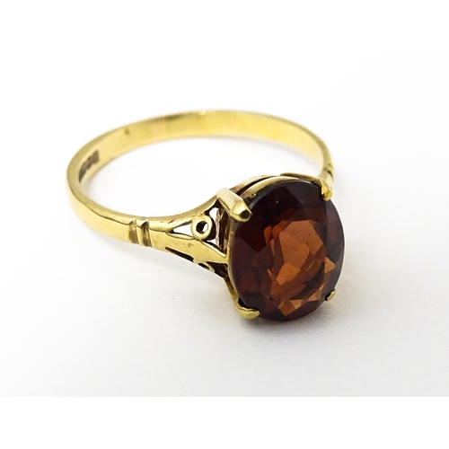 622 - A 9ct gold ring set with central garnet. Ring size approx. M