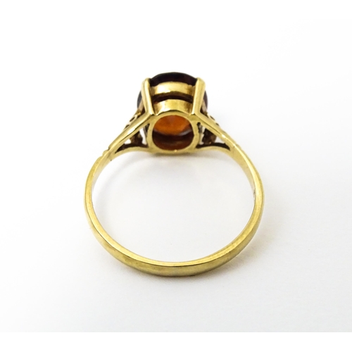 622 - A 9ct gold ring set with central garnet. Ring size approx. M