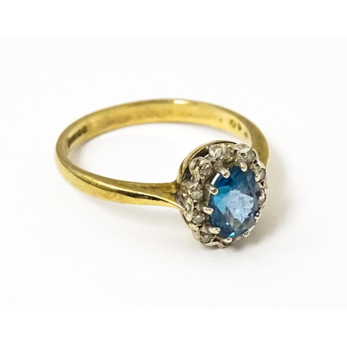 626 - A 9ct ring set with central topaz bordered by diamonds. Ring size approx. M 1/2