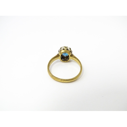 626 - A 9ct ring set with central topaz bordered by diamonds. Ring size approx. M 1/2