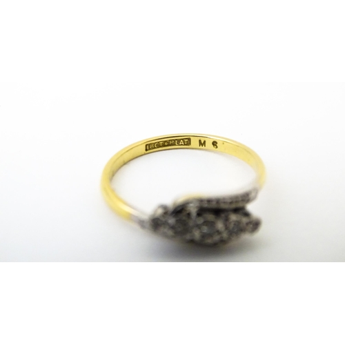 629 - An 18ct gold ring with platinum set diamonds. Ring size approx. N