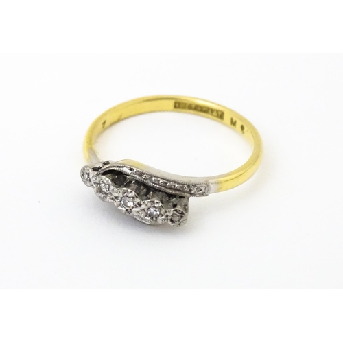 629 - An 18ct gold ring with platinum set diamonds. Ring size approx. N