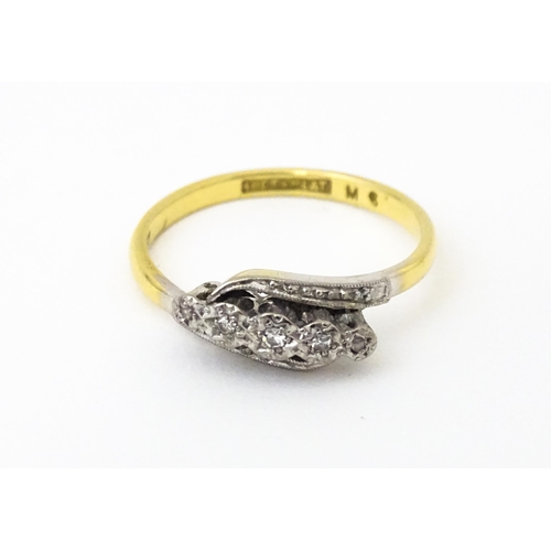 629 - An 18ct gold ring with platinum set diamonds. Ring size approx. N