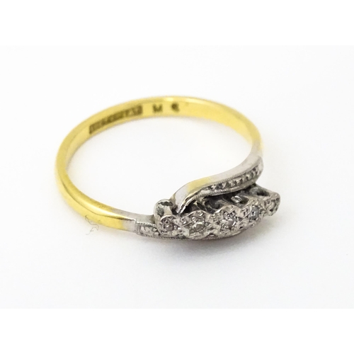 629 - An 18ct gold ring with platinum set diamonds. Ring size approx. N