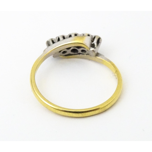 629 - An 18ct gold ring with platinum set diamonds. Ring size approx. N