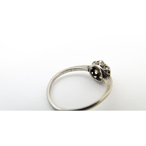 630 - A platinum ring set with six diamonds in a daisy setting. Setting approx. 1/4