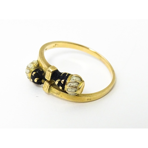 635 - A Continental yellow metal ring with enamel blackamoor head decoration. Ring size approx. L 1/2