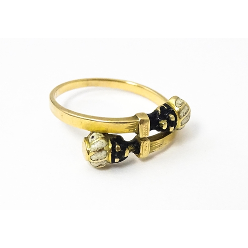 635 - A Continental yellow metal ring with enamel blackamoor head decoration. Ring size approx. L 1/2