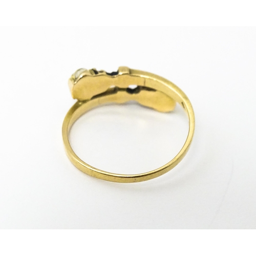 635 - A Continental yellow metal ring with enamel blackamoor head decoration. Ring size approx. L 1/2