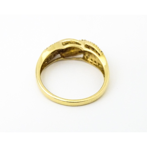 637 - A 14ct gold with twist detail set with diamonds. Ring size approx. Q 1/2