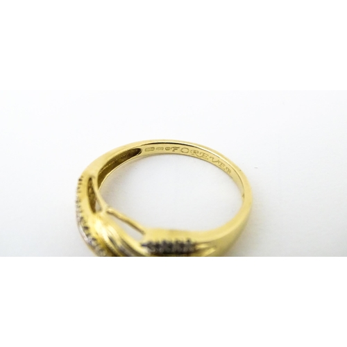 637 - A 14ct gold with twist detail set with diamonds. Ring size approx. Q 1/2