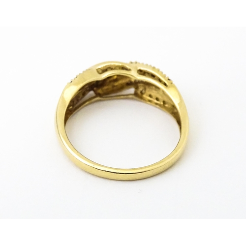 637 - A 14ct gold with twist detail set with diamonds. Ring size approx. Q 1/2