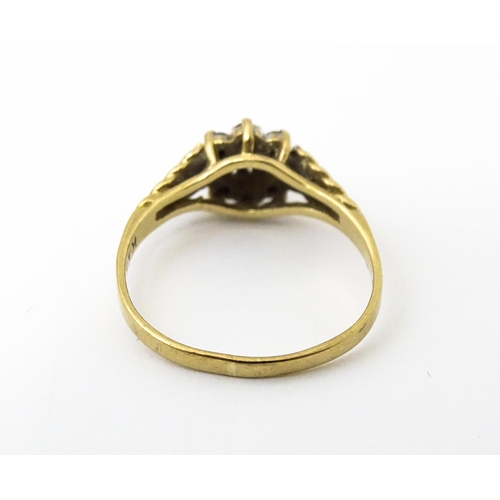 639 - A 9ct gold ring set with central diamond bordered by sapphires. Ring size approx. M