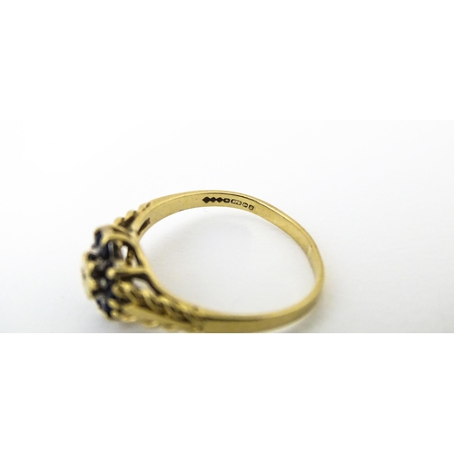 639 - A 9ct gold ring set with central diamond bordered by sapphires. Ring size approx. M