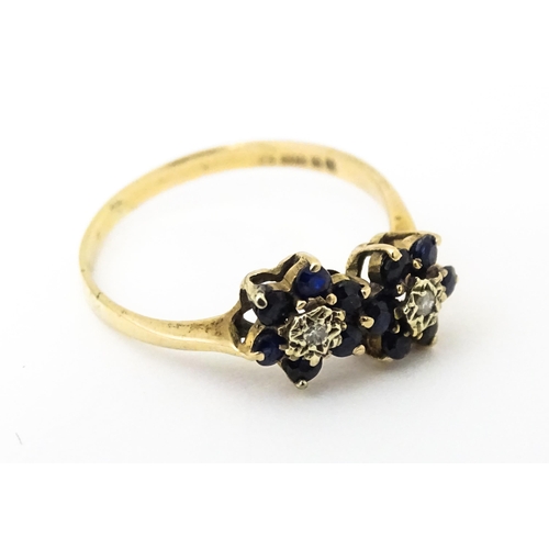 642 - A 9ct gold ring set with diamonds and spinel. Ring size approx. L