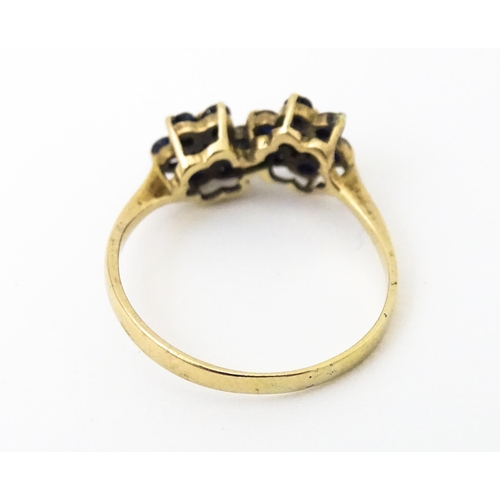 642 - A 9ct gold ring set with diamonds and spinel. Ring size approx. L