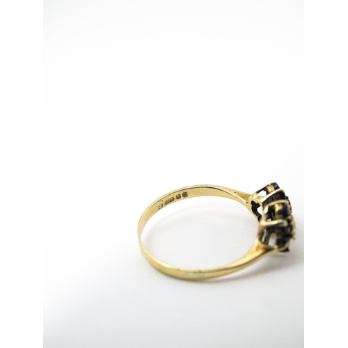 642 - A 9ct gold ring set with diamonds and spinel. Ring size approx. L