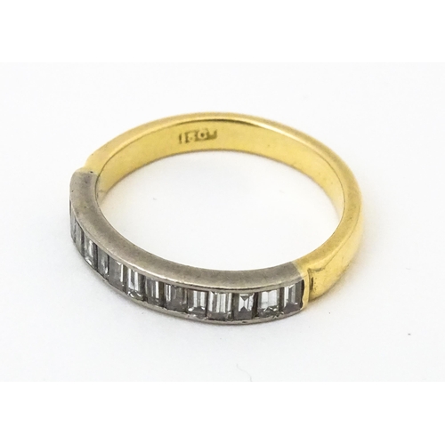 643 - An 18ct gold half eternity ring set with 15 baguette cut diamonds. Ring size approx. M 1/2