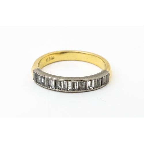 643 - An 18ct gold half eternity ring set with 15 baguette cut diamonds. Ring size approx. M 1/2