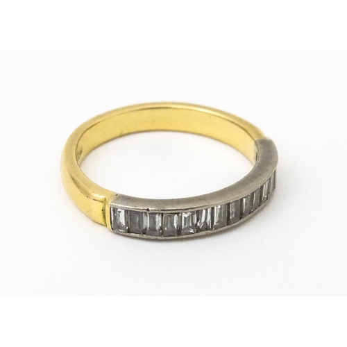 643 - An 18ct gold half eternity ring set with 15 baguette cut diamonds. Ring size approx. M 1/2