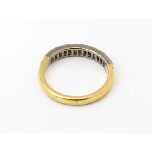 643 - An 18ct gold half eternity ring set with 15 baguette cut diamonds. Ring size approx. M 1/2