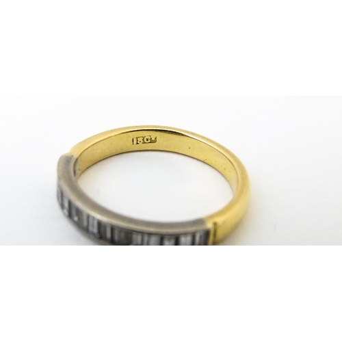 643 - An 18ct gold half eternity ring set with 15 baguette cut diamonds. Ring size approx. M 1/2