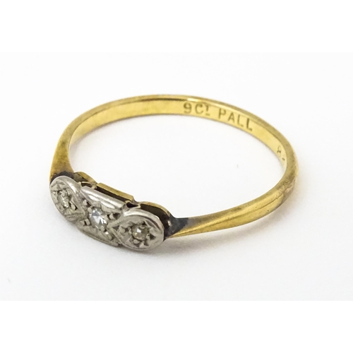 645 - A 9ct gold ring with palladium set diamonds to top in an Art deco setting. Ring size approx. O