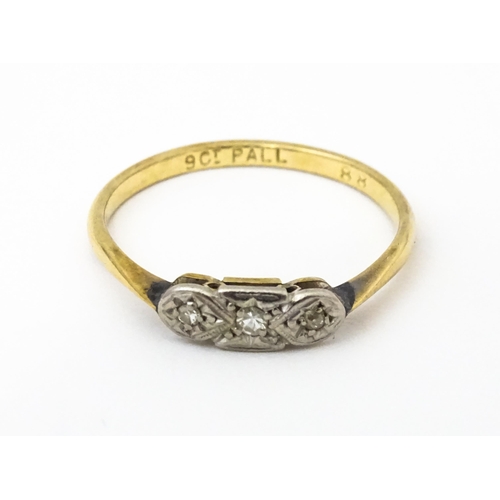 645 - A 9ct gold ring with palladium set diamonds to top in an Art deco setting. Ring size approx. O