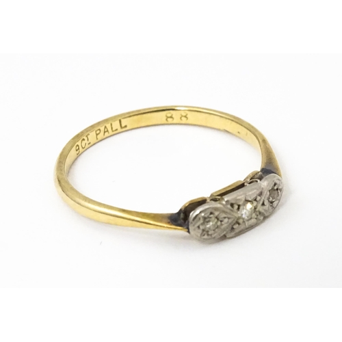 645 - A 9ct gold ring with palladium set diamonds to top in an Art deco setting. Ring size approx. O