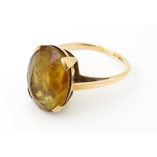 647 - A 9ct gold ring set with oval citrine. Ring size approx. P