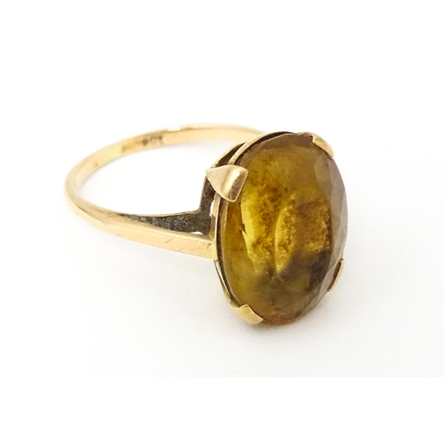 647 - A 9ct gold ring set with oval citrine. Ring size approx. P