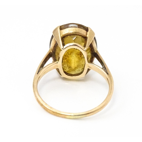 647 - A 9ct gold ring set with oval citrine. Ring size approx. P